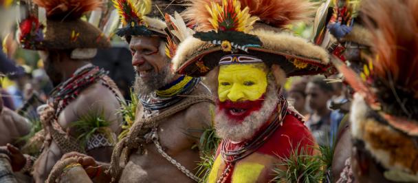 Men in face paint and traditional dress