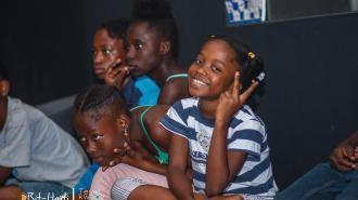 a group of people sitting and looking at the camera