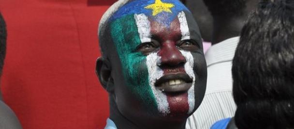 Man with South Sudan flag painted on face