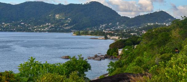 a body of water with a mountain in the background