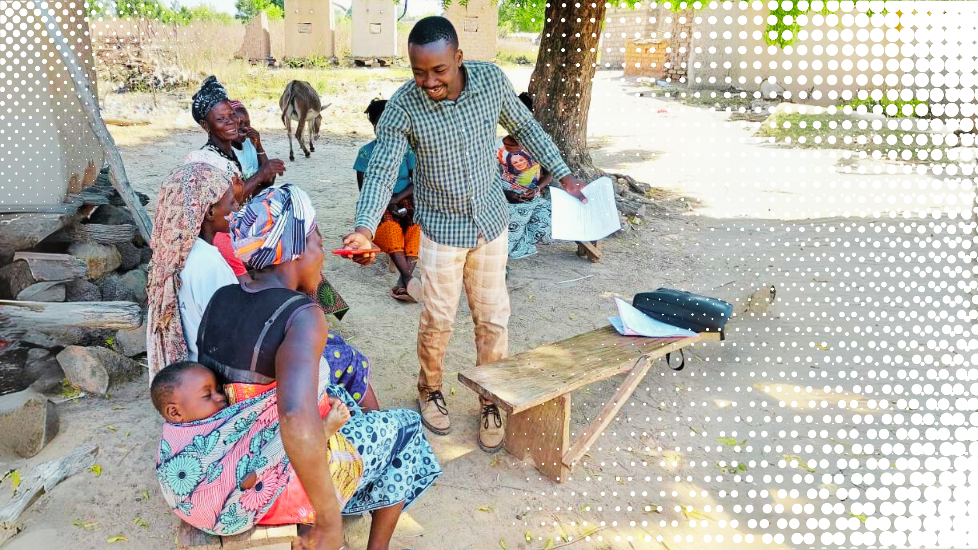 A man speaks with a woman carrying a child on her back